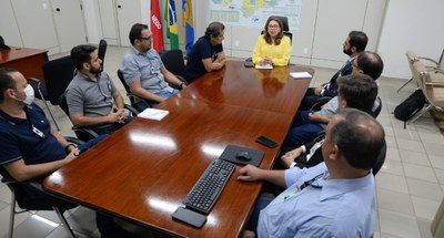 #PraTodosVerem: Na fotografia aparecem pessoas sentadas em uma ampla mesa de reunião, sendo uma ...