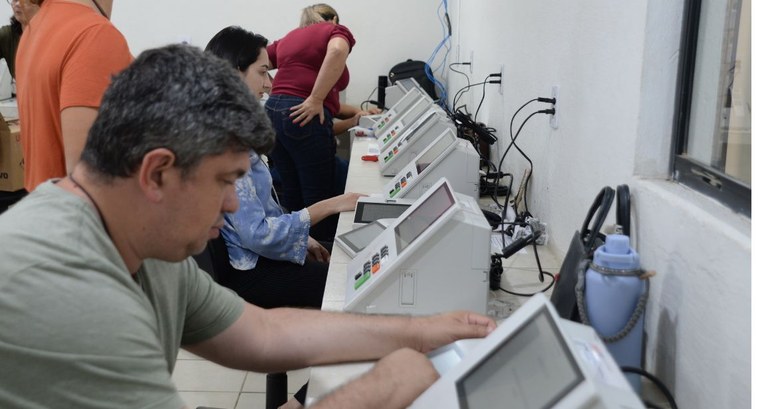 #PraTodosVerem: Na fotografia aparece mulheres e homens realizando a preparação das urnas.